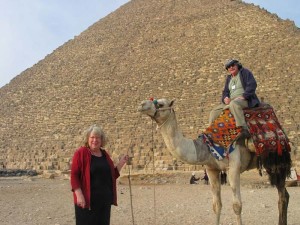 Margret short with camel in front of Egyptian pyramids