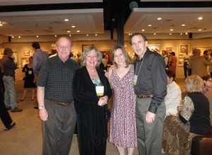 Margret short with guests at large art gallery showing