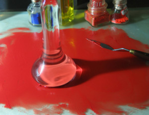 red paint on table with pallet knife